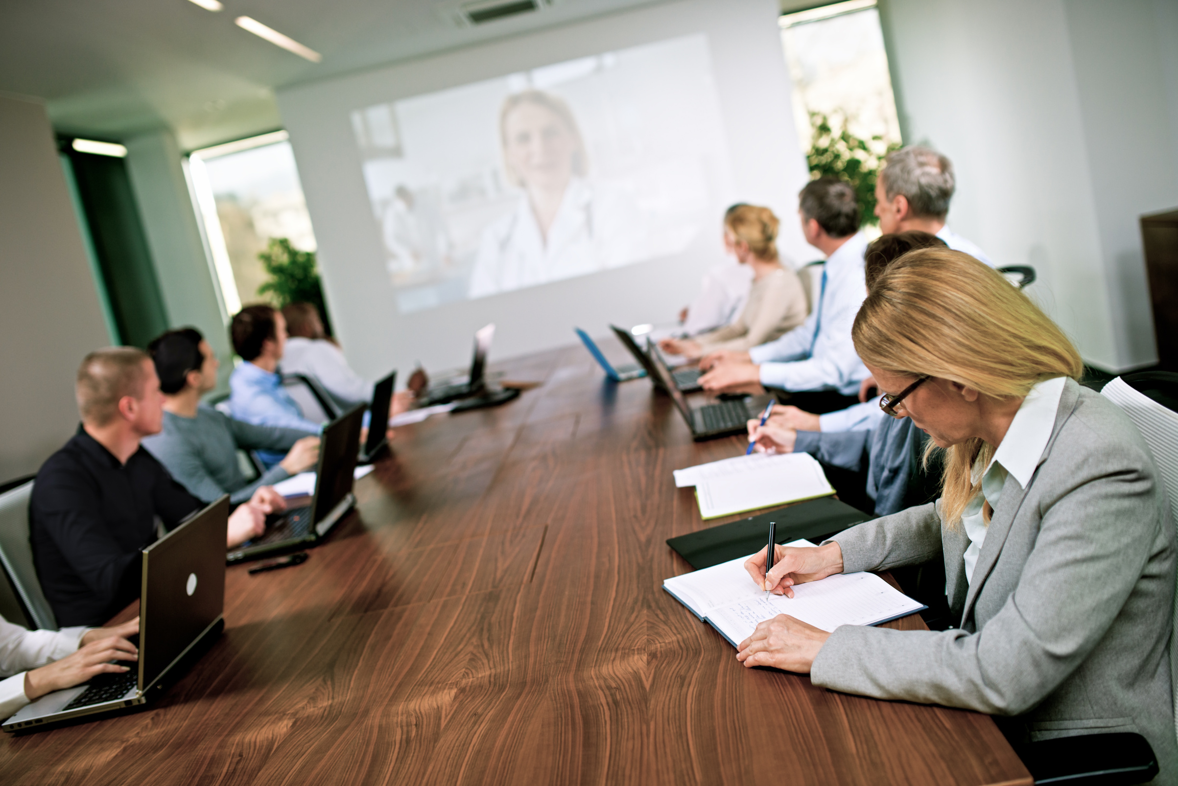 Committee Having Video Conference in the Boardroom